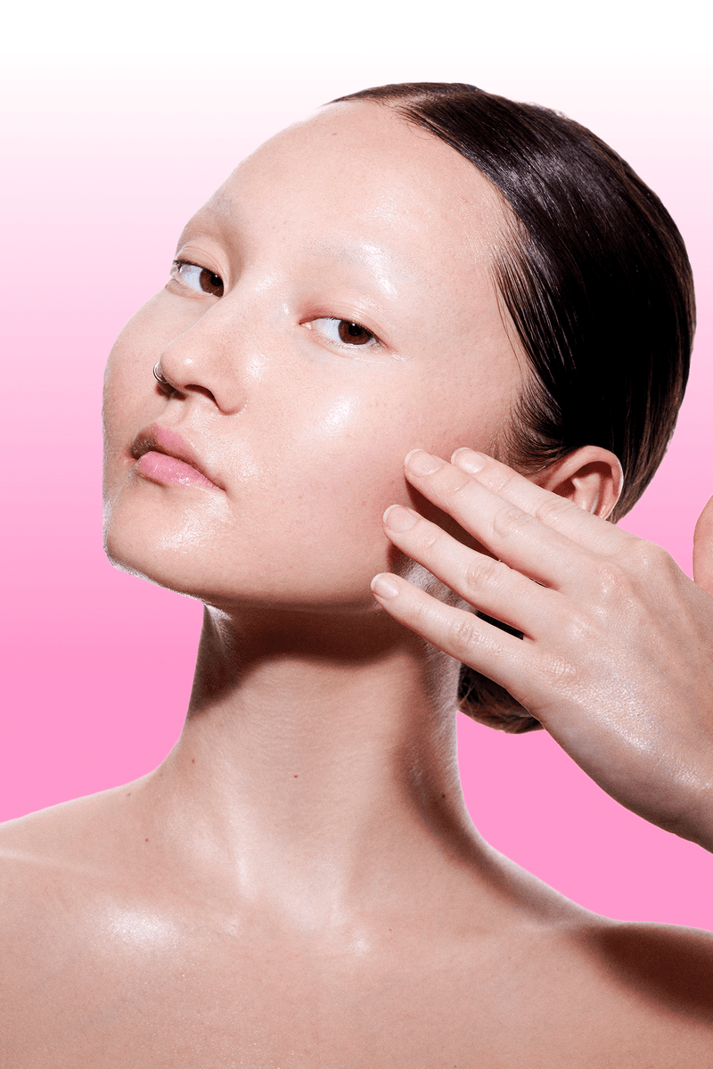 futurewise, korean skincare, slugging, woman with bright makeup wiping her band on face, cleanser