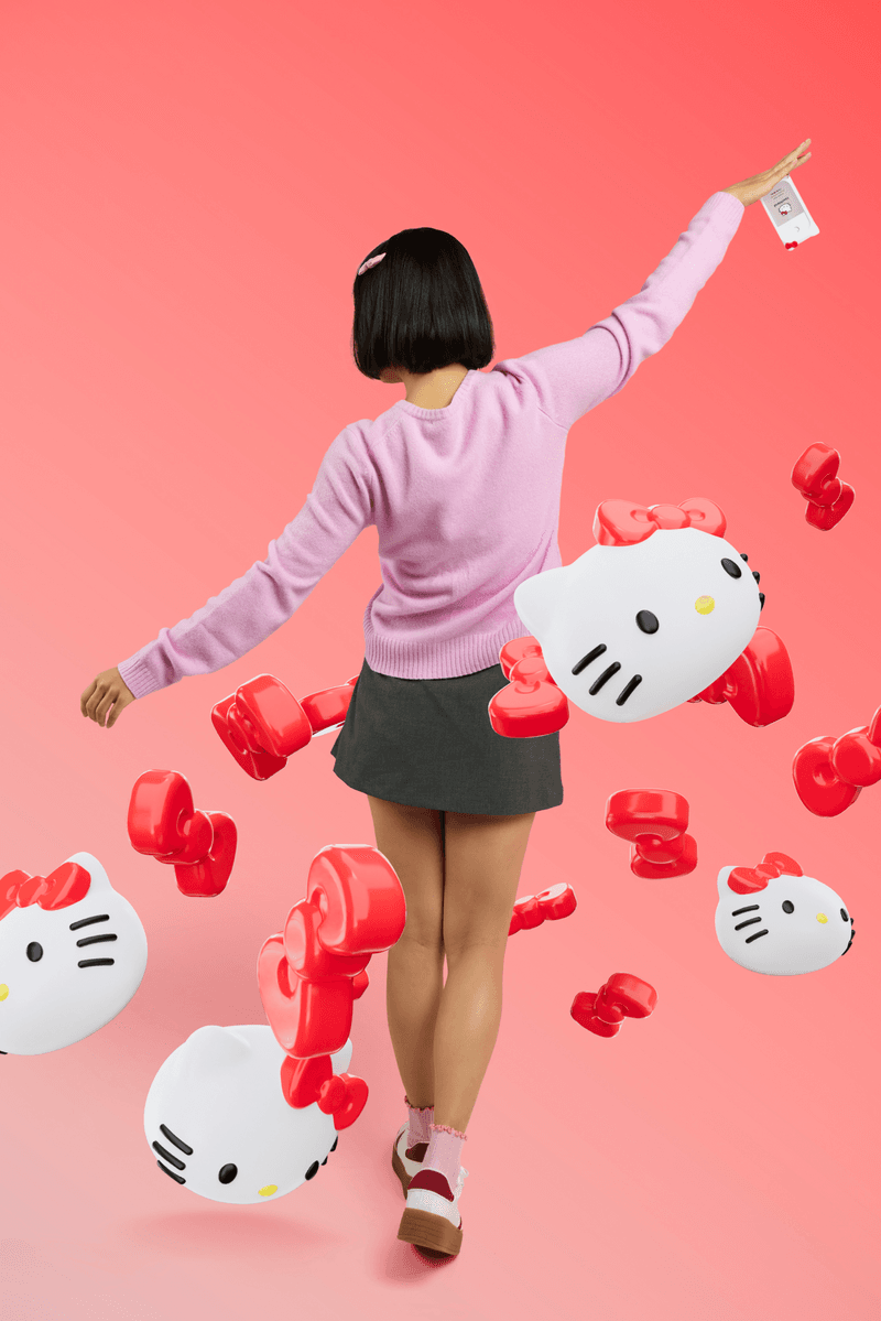 woman with bob surrounded by hello kitty sanrio touchland hand sanitizers, beauty, 50th anniversary