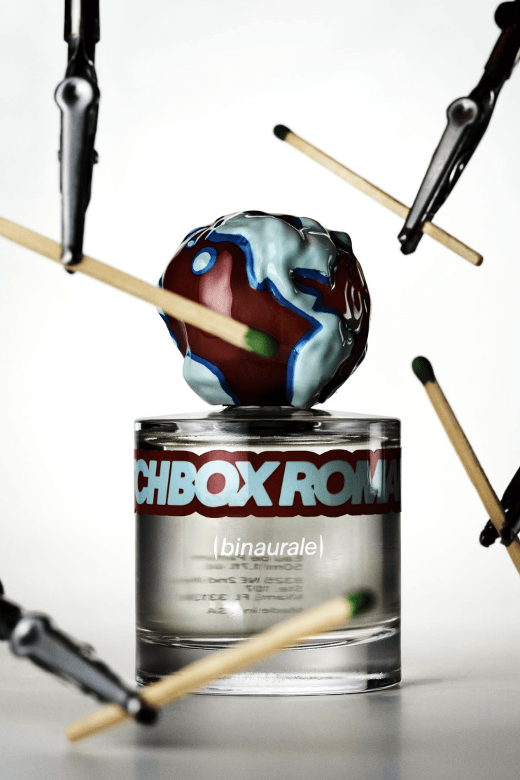 person with gloves carrying four perfumes from binaurale, matchbox romance