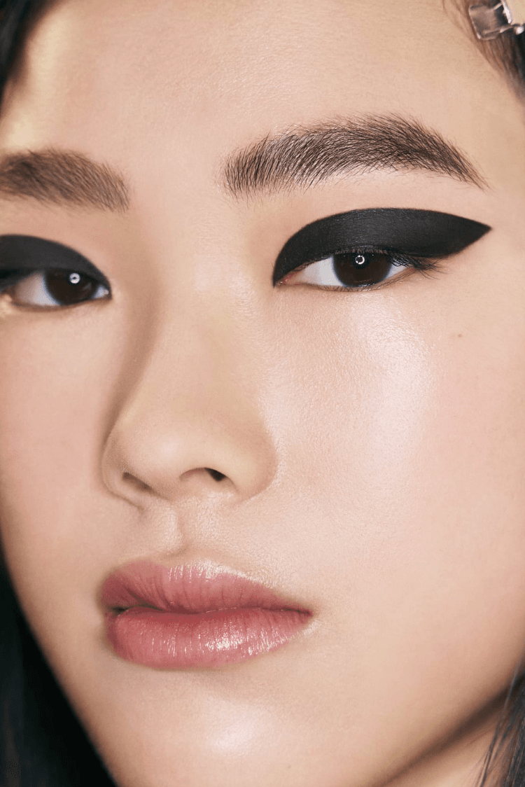 two women with black eyeliner makeup, chanel beauty, fashion