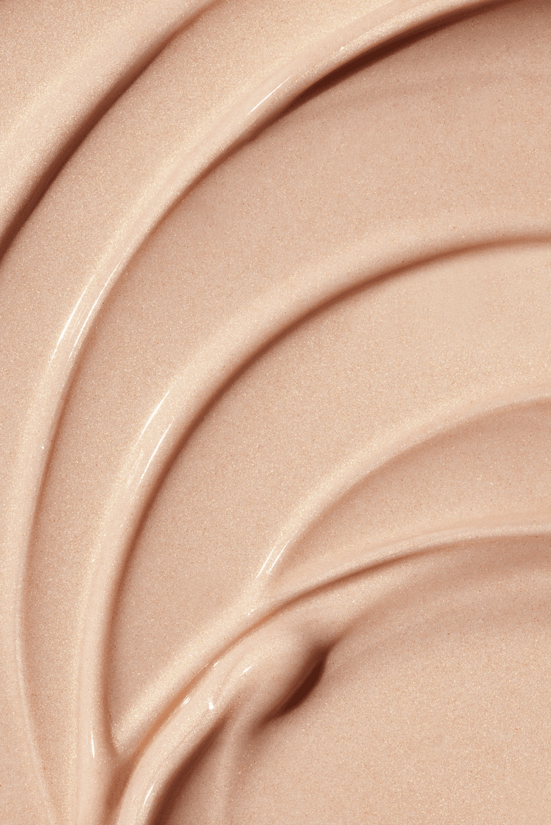 woman caressing bottle of saie beauty glowy super gel in warm glow, swatch of highlighting primer, makeup, skincare