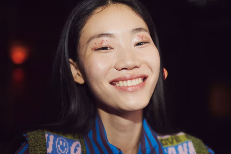 women smiling with glitter on her eyes, new year's eve makeup, glitter, ganni runway show, beauty