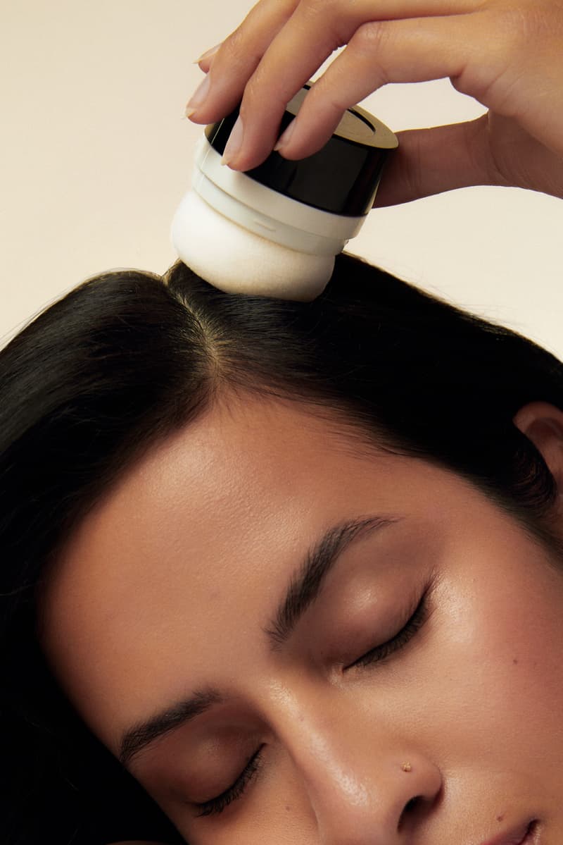 model applying dry shampoo in a powder puff, babba rivera, latinx haircare, hair, beauty