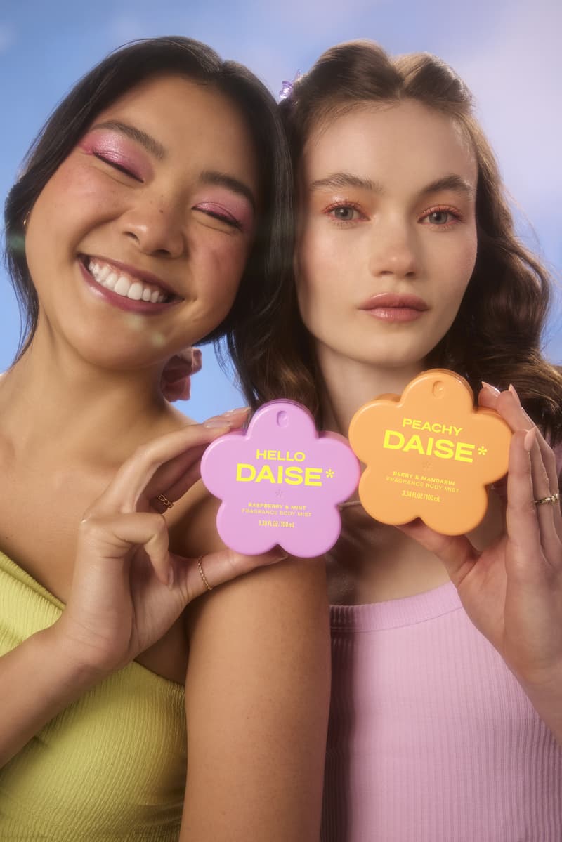 three women with colorful eyeshadow, posing with daise perfume bottles, fragrance, mood boosters, beauty