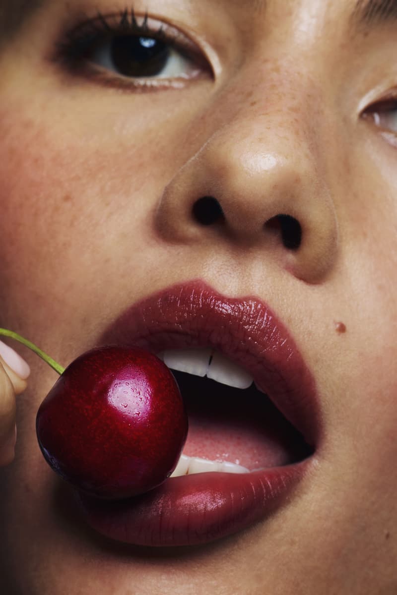 woman with cherry in her mouth, cherry-colored makeup roundup, glossier, beauty