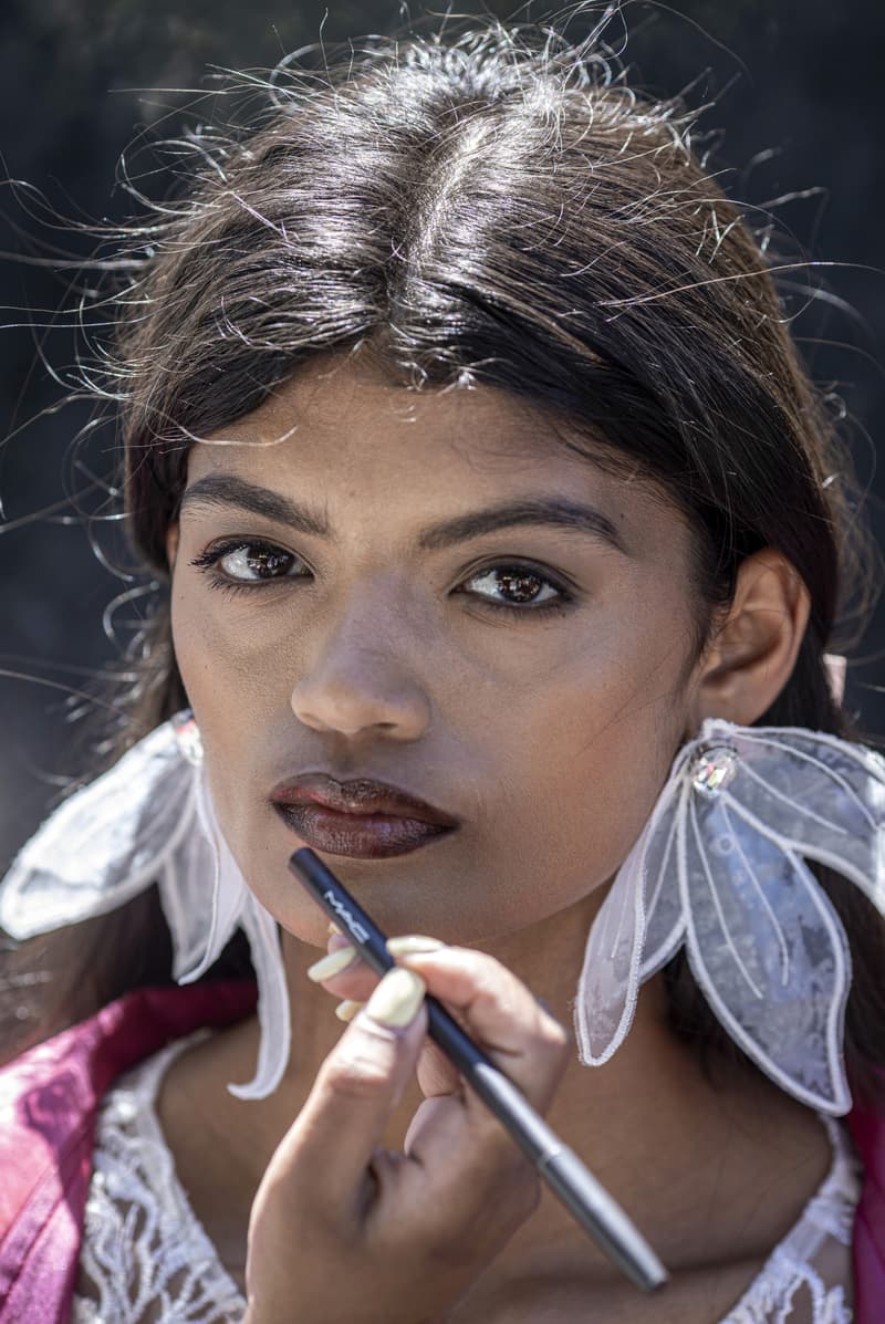 woman getting her makeup done with mac lip liner, when to throw away your makeup explainer, beauty