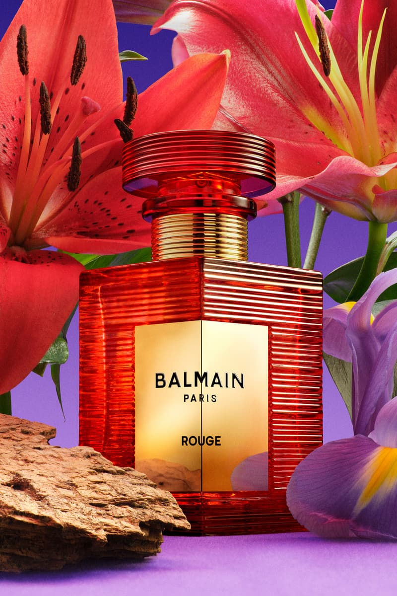 two woman posing across from each other with big gold earrings and red lipstick, new rouge perfume from balmain beauty, fragrance