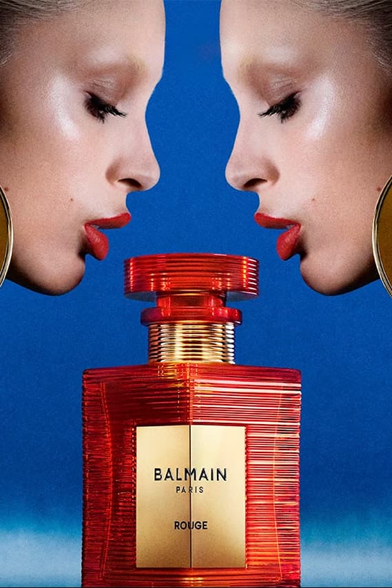 two woman posing across from each other with big gold earrings and red lipstick, new rouge perfume from balmain beauty, fragrance