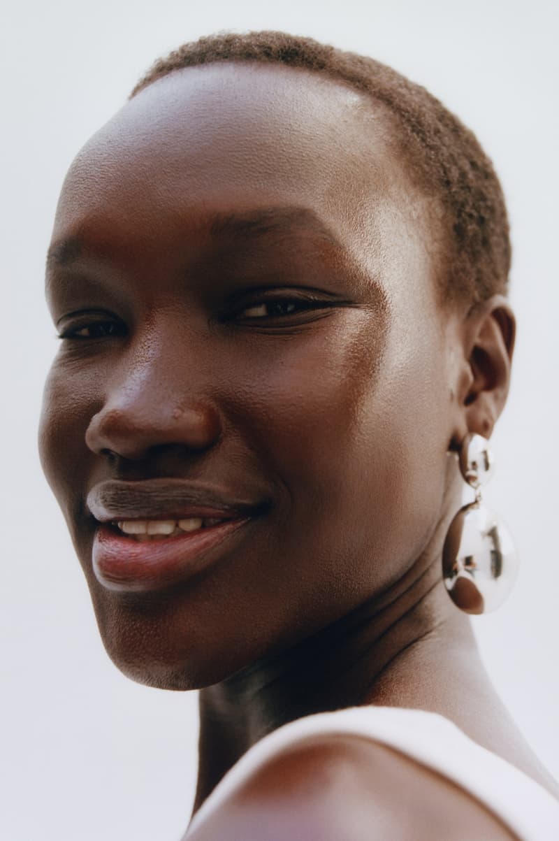 woman posing with new glossier futuredew solid serum, skincare-makeup hybrid, beauty