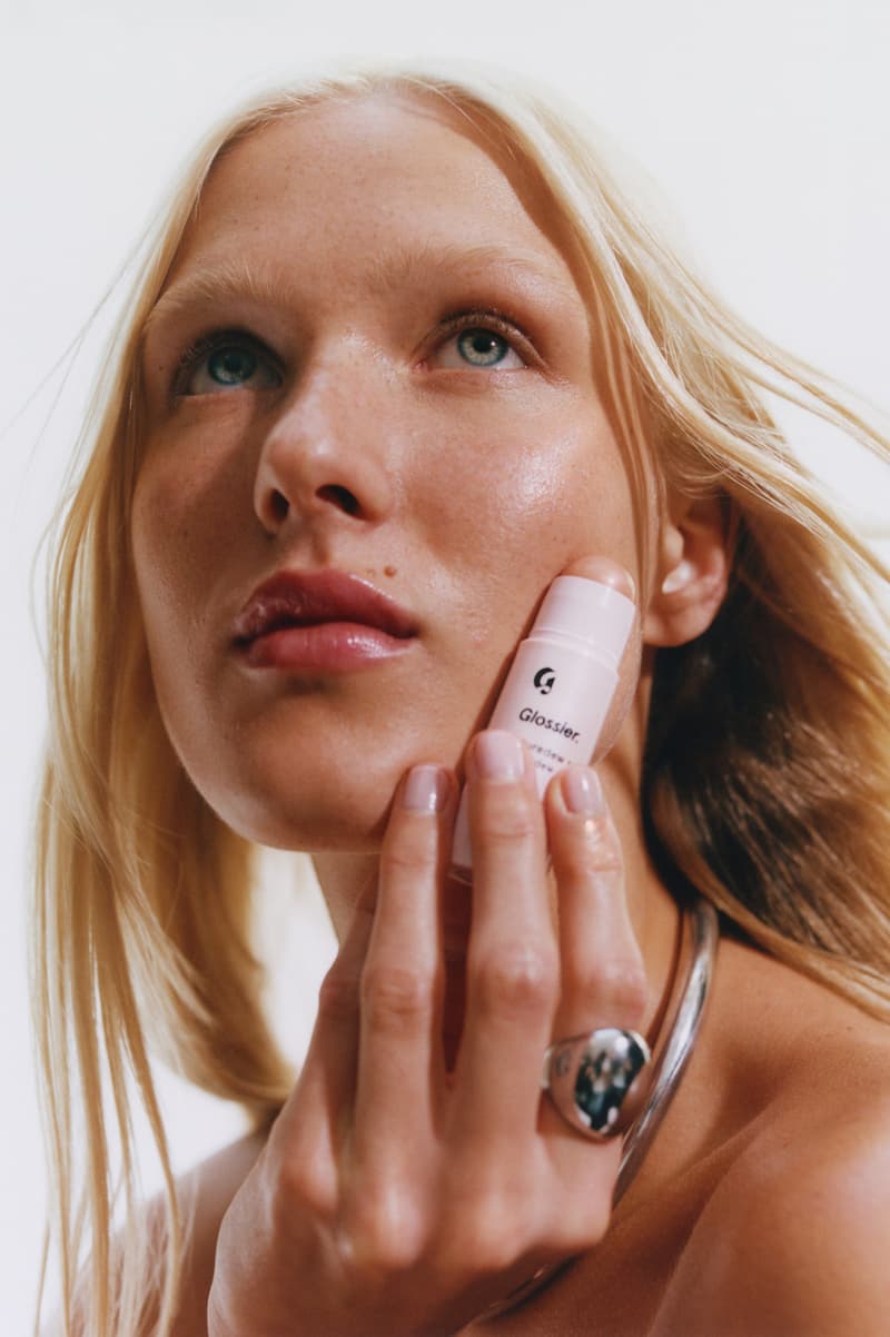 woman posing with new glossier futuredew solid serum, skincare-makeup hybrid, beauty