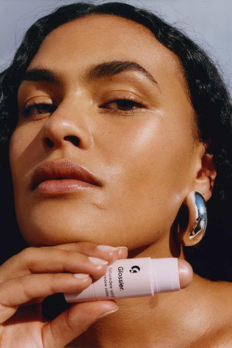 woman posing with new glossier futuredew solid serum, skincare-makeup hybrid, beauty