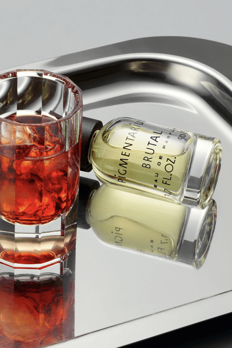 fragrance on chrome tray with negroni drink, pigmentarium "brutal" perfume, beauty