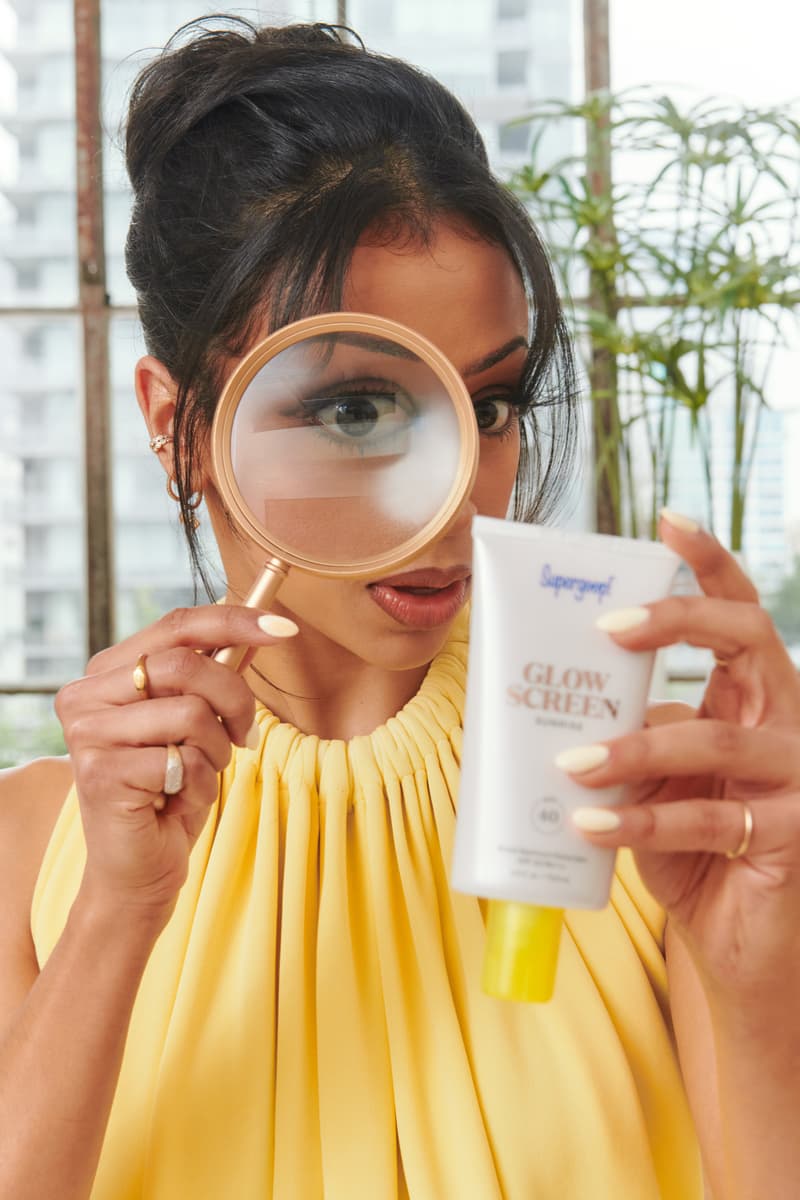 liza koshy posing with supergoop sunscreen, wearing new sunglasses, sunscreen, skincare, beauty
