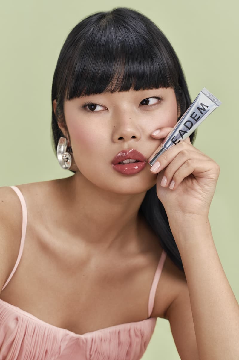 woman licking lollipop, eadem chou chou lip balm in guava fresca skincare makeup beauty