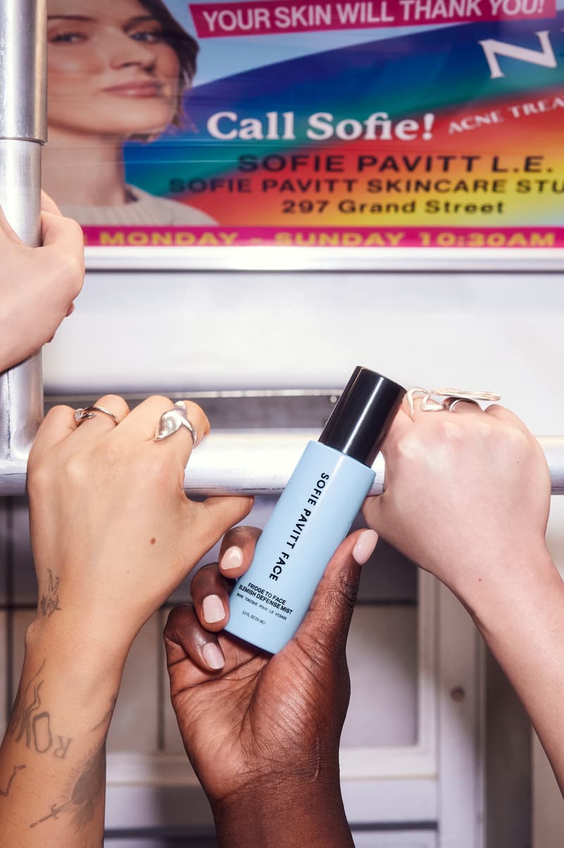 woman in the subway spraying skincare mist on her face, sofie pavitt skincare, beauty