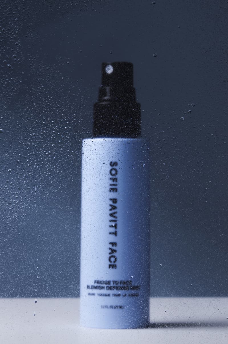 woman in the subway spraying skincare mist on her face, sofie pavitt skincare, beauty 