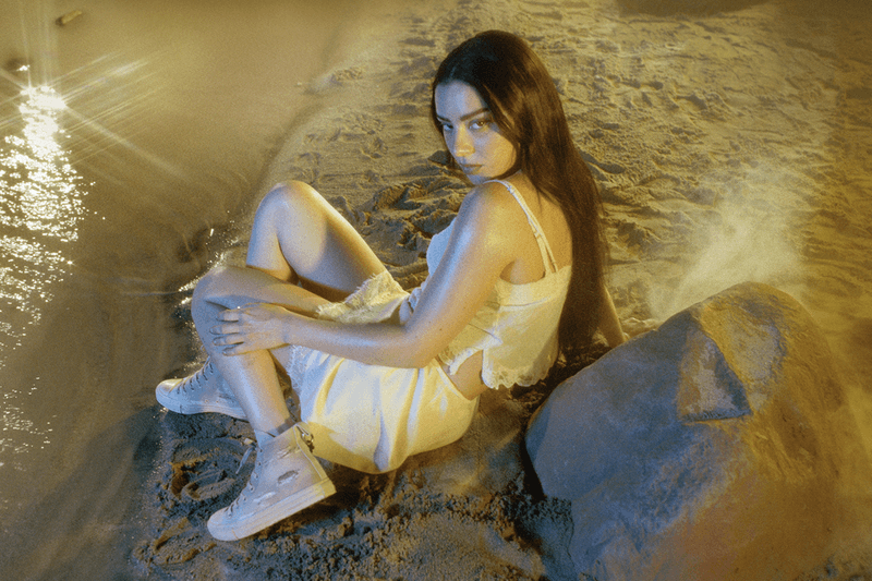 charli xcx, converse, white sneakers, girl laying, singer