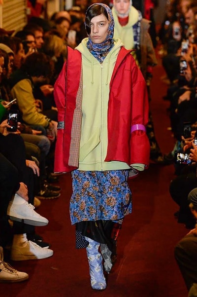 デムナワールドが炸裂した Vetements 2018年秋冬コレクション ストリート＆オーバーサイズという真骨頂の中でスカーフと壊滅的なミリタリーパンツを提案した圧巻のランウェイ パリファッションウィークの公式スケジュールから脱退した〈Vetements（ヴェトモン）〉が、レッドカーペットを敷き詰めた会場で宣言通りの単独ショーを開催した。ストリートとルーズシルエットというDemna Gvasalia（デムナ・ヴァザリア）の真骨頂の中で印象的に映るのは、スカーフの提案と壊滅的に近いミリタリーパンツのダメージ加工。落書きやワッペンの配置、多様多種な柄物のミックスからは、80年代〜90年代のヴィンテージ古着に見るカオティックな雰囲気が漂うほか、Marilyn Manson（マリリン・マンソン）のシャツなども組み込まれ、何とも形容し難いDemnaならではの世界観を構築して観衆を釘付けにした。 ちなみに、下のInstagramの動画はインビテーションであるレシートを撮影したもの。見応え満載の全57体のルックはフォトギャラリーからご確認を。 〈Vetements〉と〈Reebok（リーボック）〉によるブルーを効かせたGenetically Modified Pumpの限定カラーもお買い逃しのないように。