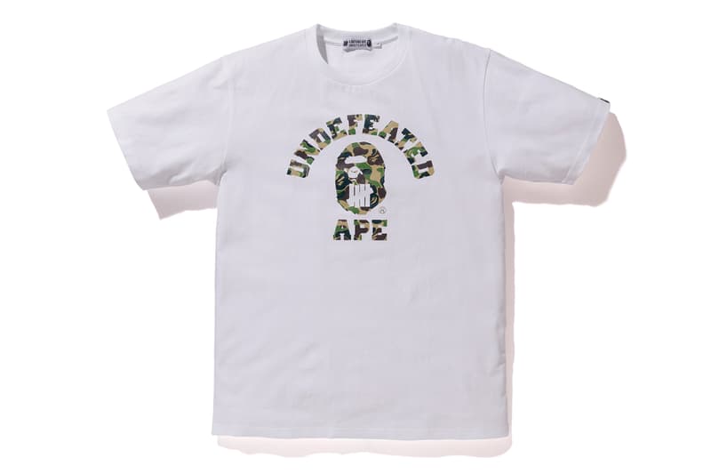 BAPE®️ x UNDEFEATED の強力タッグによるコラボカプセルコレクション第4弾が登場 両者のロゴをミックスしたインパクト抜群のM-65やスウェットセットアップは必見 カリフォルニア州 ロサンゼルス 旗艦店 A BATHING APE®️ BAPE®️ ベイプ ア ベイシング  エイプ UNDEFEATED アンディフィーテッド APE HEAD ファイブストライクスロゴ グリーン パープル BAPE®️ CAMO M-65 フーディ Tシャツ スウェットパンツ 6ポケットパンツ James Bond ジェームス・ボンド 転売カルチャー HYPEBEAST ハイプビースト