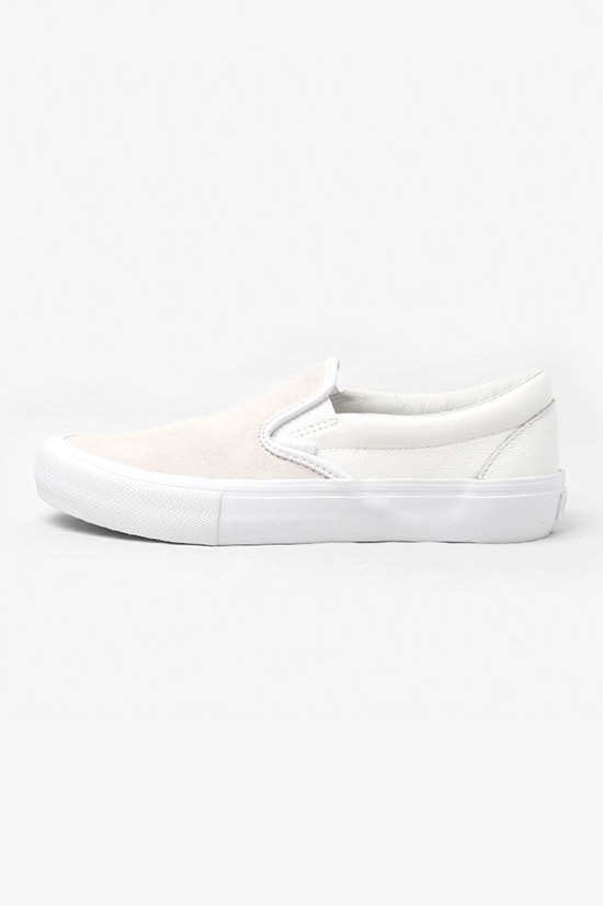 Engineered Garments x Vans Classic Slip-on VLT LX の国内発売が決定 スムースレザーとスエードで前後のパーツを切り替え、さらに左右の足でも非対称に配置したシャープながらも個性的な逸足  先日、『Nepenthes New York』にてリリースされた〈Engineered Garments（エンジニアド ガーメンツ）〉と〈Vans（ヴァンズ）〉の最新コラボスニーカーの国内取扱情報が舞い込んできた。リリースの度に注目を集める〈EG〉x〈Vans〉だが、今回はソールや履き口のクッション部分もアップデートされたClassic Slip-on VLT LXをベースに採用。アッパーを両者のコラボではお馴染みのアシンメトリックデザインとなっており、スムースレザーとスエードで前後のパーツを切り替え、さらに左右の足でも非対称に配置されている。  ピスネーム、ヒールパッチ、インソールのロゴ、アウトソールに至るまで全てワントーンで統一することで洗練されたシャープな印象を放ちつつ、〈EG〉ならではの個性も宿した本作は、ホワイト、ダークネイビー、レッド、カーキの全4色展開で、7月13（金）より『NEPENTHES（ネペンテス）』各店にて発売開始。価格は、13,000円（税抜）となっている。  あわせて、ありそうでないデザインが目を奪う〈Vans〉x『size?（サイズ）』のStyle 36 “Pony Hair”パックもチェックしてみてはいかが？