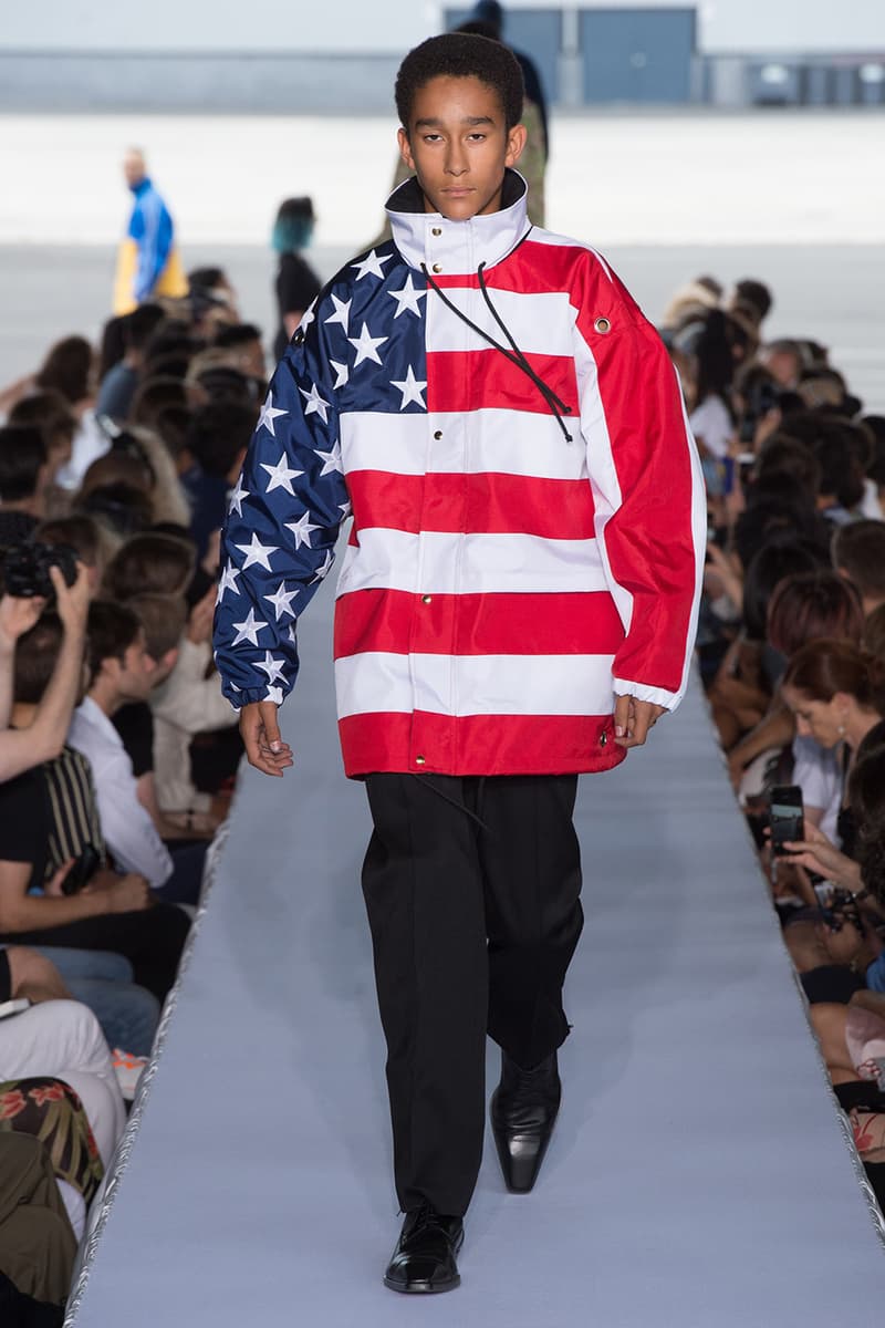 戦争で刻まれた恐怖心と怒りを投影した Vetements 2019年春夏コレクション デムナの母国である現ジョージアとロシア連邦間の紛争をテーマに採用 Demna Gvasalia デムナ・ヴァザリア Vetements ヴェトモン グルジア ジョージア 南オセチア紛争 グラフィックフーディ Tシャツ フィールドジャケット カーゴパンツ トゲを配したハイカットブーツ Reebok リーボック HYPEBEAST ハイプビースト
