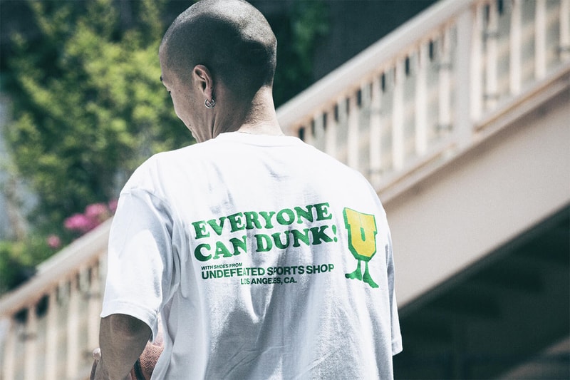 アンディフィーテッドがナイキ ダンク ブラジルを記念したTシャツをリリース UNDEFEATED が Nike Dunk Low “Brazil” の復刻リリースを記念したスペシャルTシャツをリリース