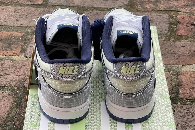 フライトにインスパイアされたユニオン x ナイキ ダンク ロー “Midnight Navy” のビジュアルが浮上 Detailed Look at the Union x Nike Dunk Low Midnight Navy First Look Release date info grid pattern frontman logo silver grey reflective flight tag baggage passport plane un la green mint blue