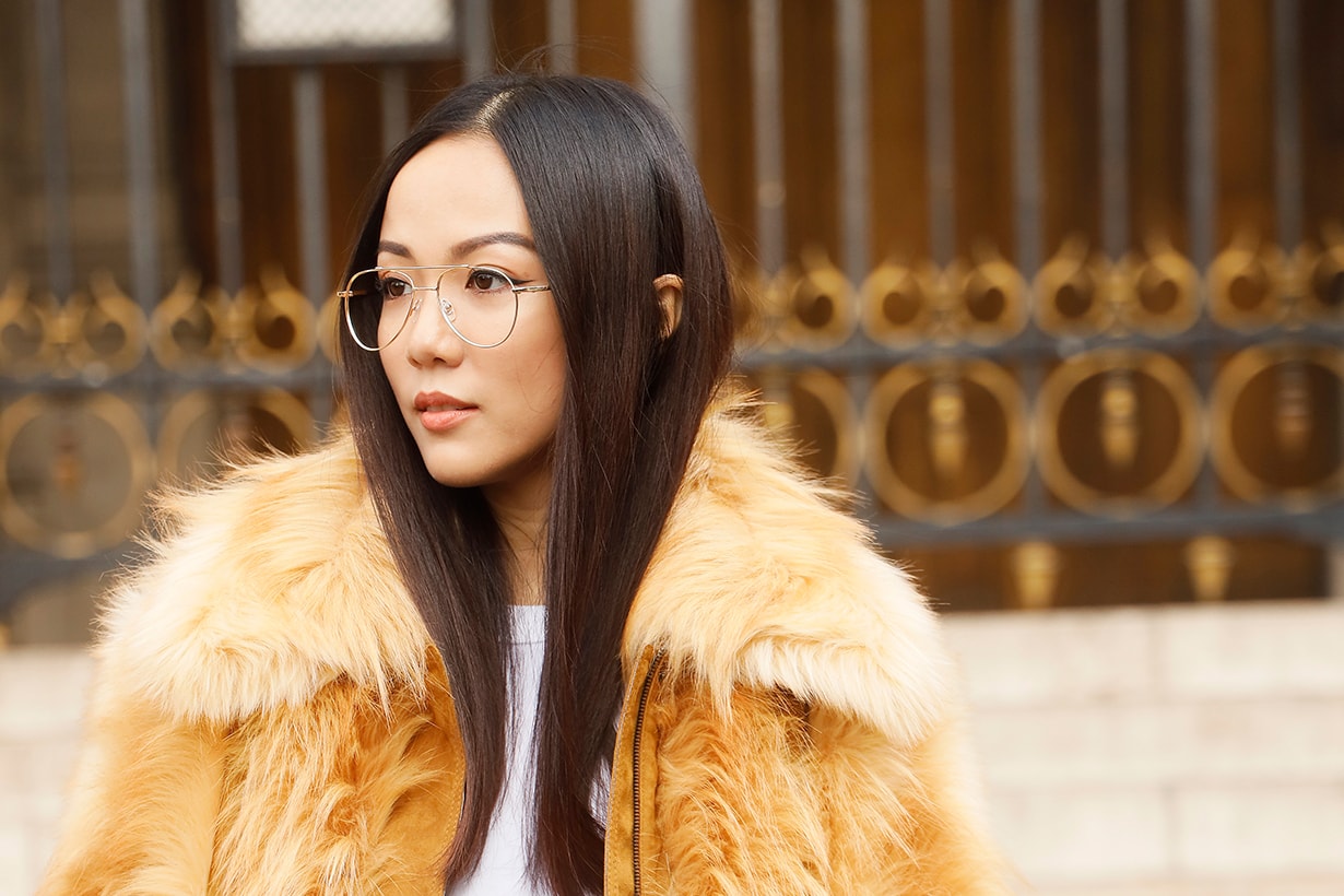 Yoyo Cao wearing a brown fur coat and whit edenim outside Stella McCartney during Paris Fashion Week Womenswear Spring Summer 2020 on September 30, 2019 in Paris, France.