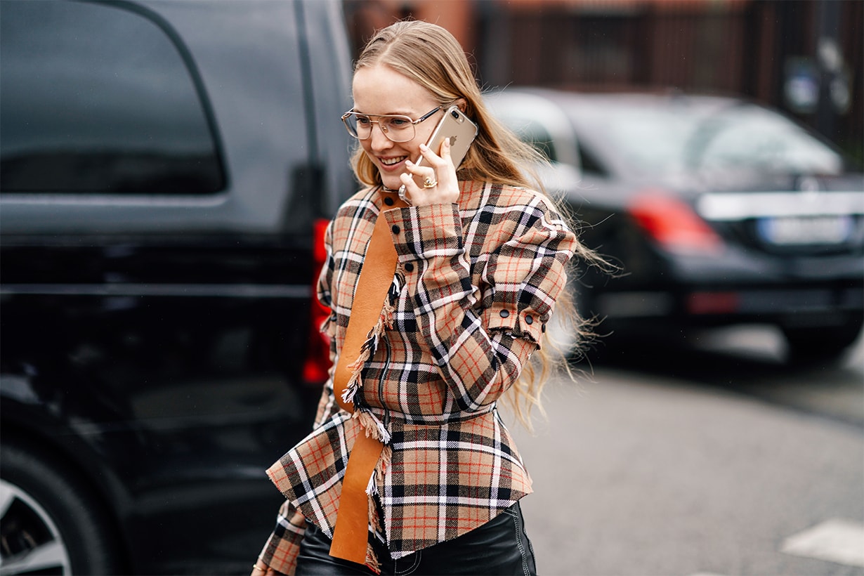 A guest wears a brown and orange checkered shirt, outside Nina Ricci, during Paris Fashion Week Womenswear Fall/Winter 2019/2020, on March 01, 2019 in Paris, France.