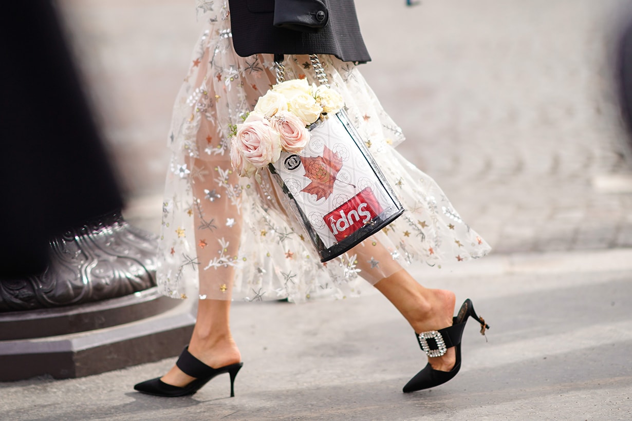 A Supreme bag with flowers is seen, outside Chanel, during Paris Fashion Week Womenswear