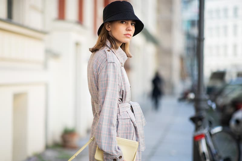 Swantje Sömmer is seen wearing belted plaid coat Munthe, black COS bucket hat, Celine bag