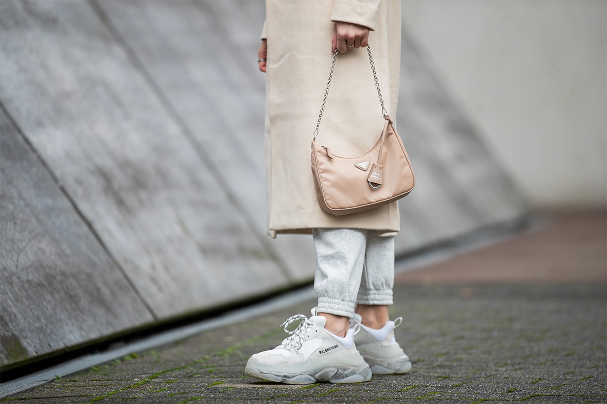 Inga Brauer is seen wearing grey jogger pants H&M, creme white coat &other stories, Triple S sneaker Balenciaga, beige bag Prada mulit-pochette reedition 2005 on January 25, 2020 in Dusseldorf, Germany.