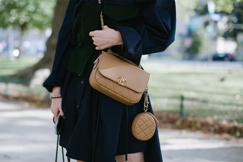 A guest poses wearing a Sacai dress and a Chanel bag after the Sacai show at the Grand Palais during Paris Fashion Week - Womenswear Spring Summer 2020 on September 30, 2019 in Paris, France.