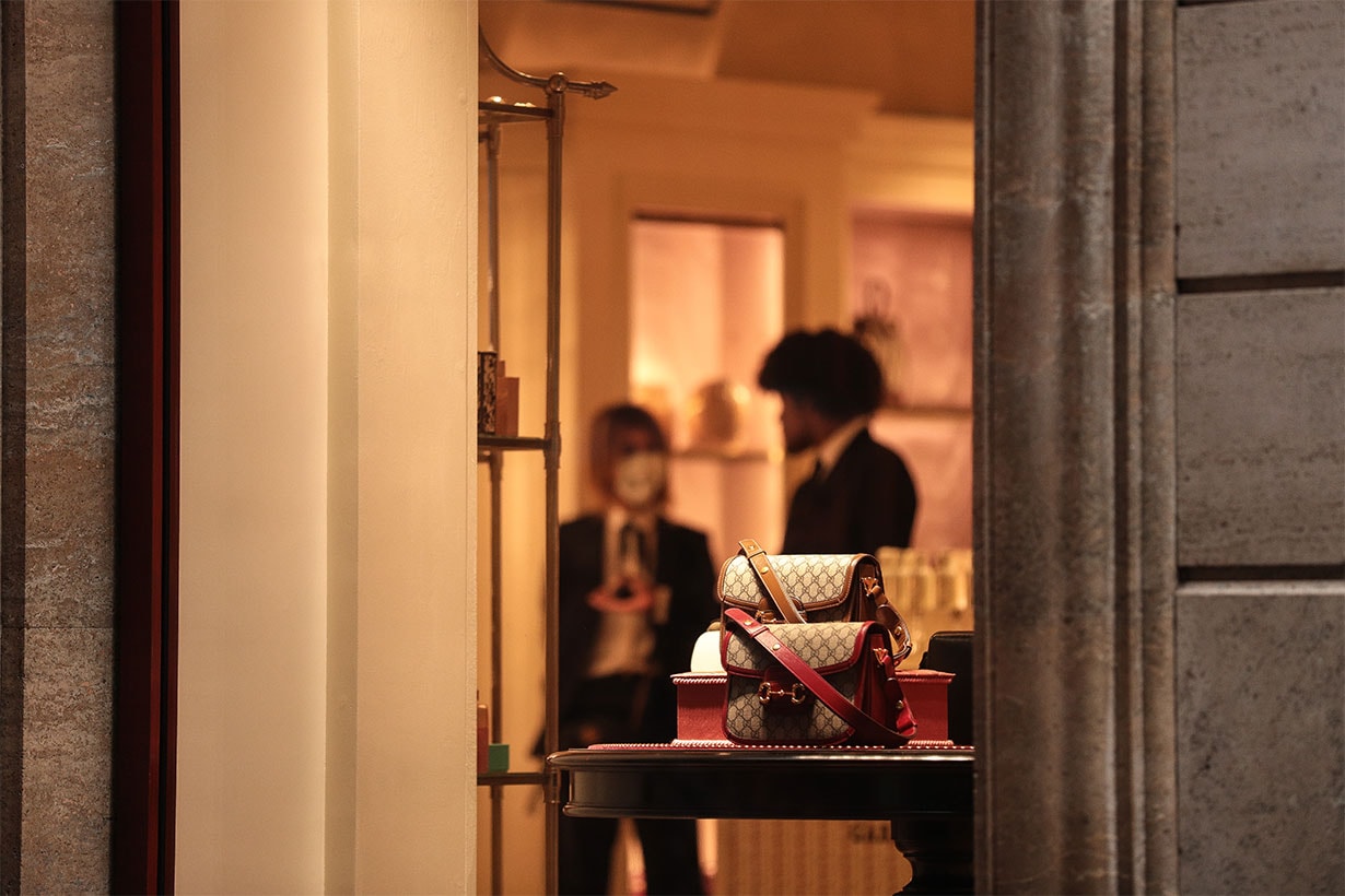 A shop assistant wearing a protective respiratory mask inside a luxury showroom in downtown Rome