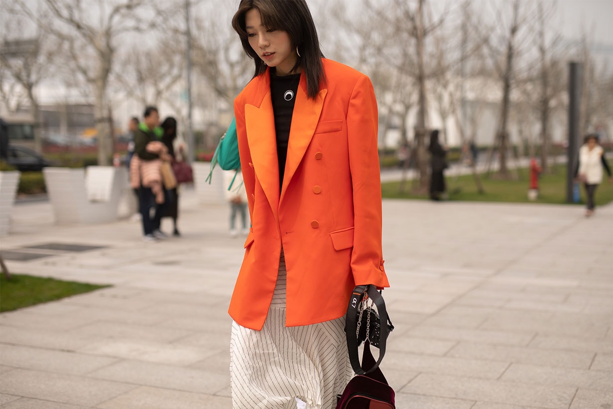 A guest is seen on the street attending Labelhood during Shanghai Fashion Week A/W 2019/2020 wearing orange blazer