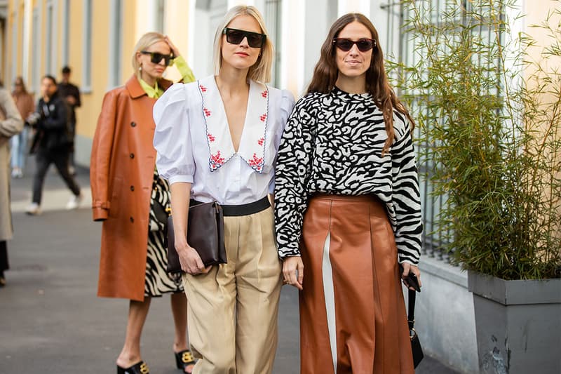 Linda Tol wearing camel pants and white blouse and Erika Boldrin wearing jumper with zebra print, brown white skirt is seen outside Tods during Milan Fashion Week Fall/Winter 2020-2021 on February 21, 2020 in Milan, Italy.