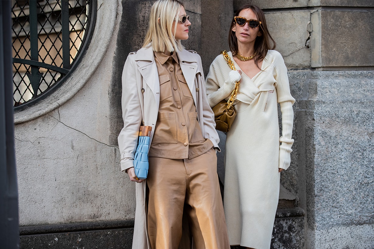 Linda Tol is seen wearing trench brown button shirt, shorts and Chloe Harrouche is seen wearing dress, brown bag, golden necklace, Bottega heels outside Max Mara during Milan Fashion Week Fall/Winter 2020-2021 on February 20, 2020 in Milan, Italy.