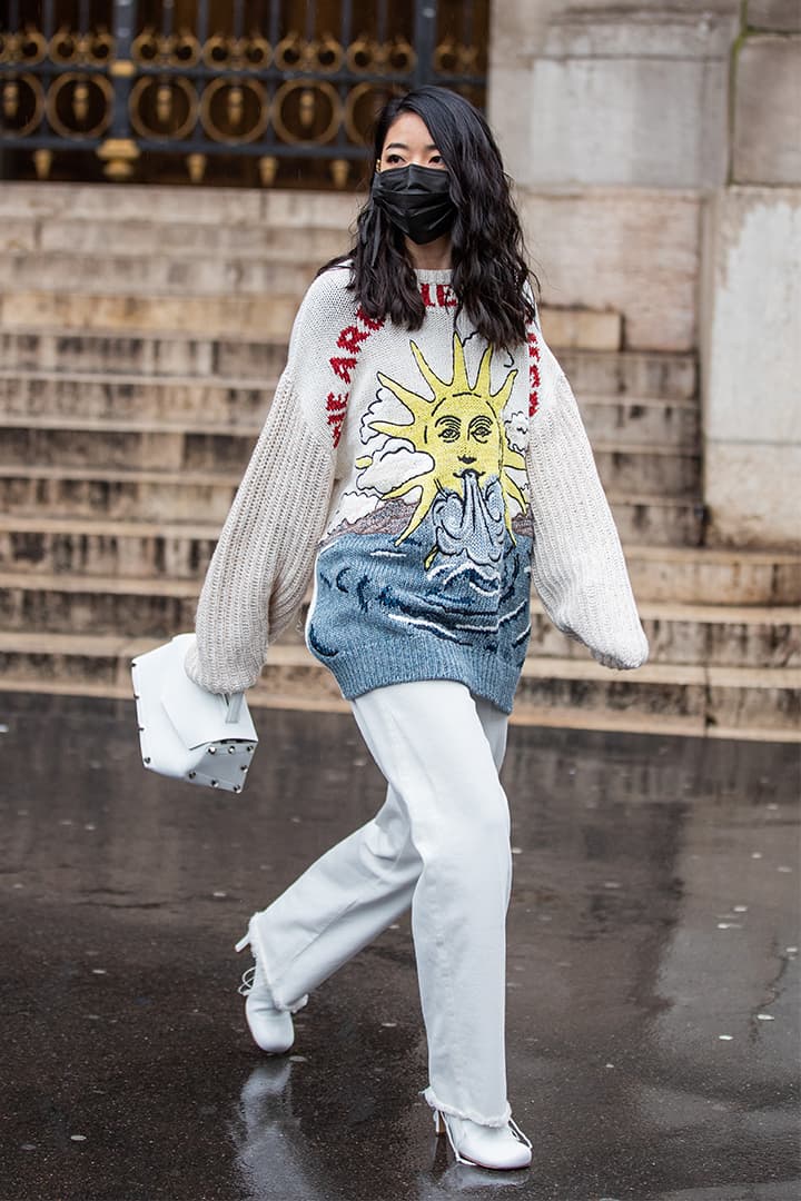 Yuwei Zhangzou is seen wearing black face mask, knit with graphic print outside Stella McCartney during Paris Fashion Week - Womenswear Fall/Winter 2020/2021 : Day Eight on March 02, 2020 in Paris, France.