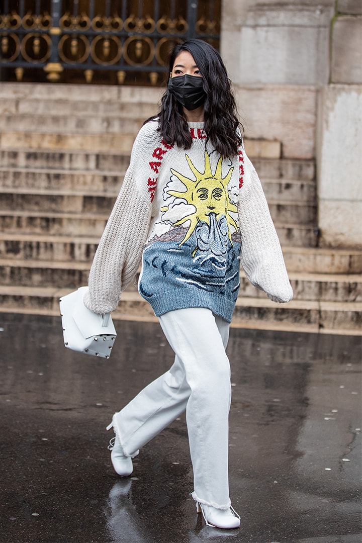 Yuwei Zhangzou is seen wearing black face mask, knit with graphic print outside Stella McCartney during Paris Fashion Week - Womenswear Fall/Winter 2020/2021 : Day Eight on March 02, 2020 in Paris, France.
