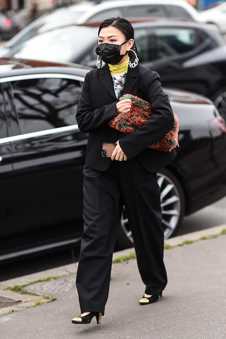 A guest is seen wearing a Balmain suit and black mask outside the Balmain show during Paris Fashion Week: AW20 on February 28, 2020 in Paris, France.
