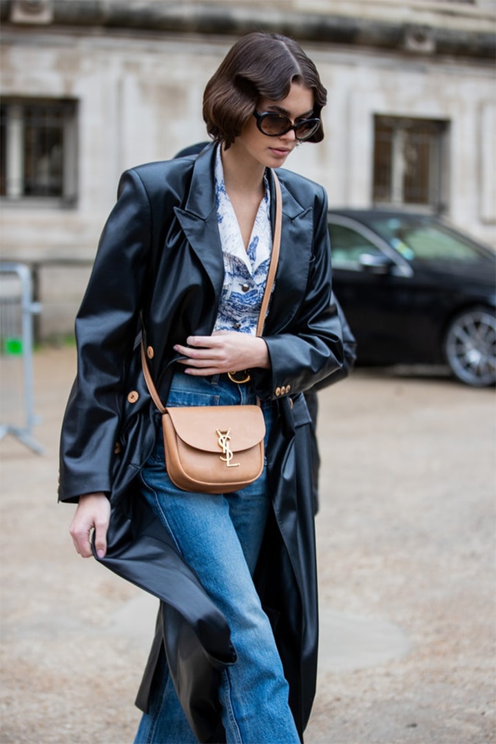 Kaia Gerber is seen wearing YSL bag, black coat, denim jeans outside Chloe during Paris Fashion Week Womenswear Fall/Winter 2020/2021 : Day Four on February 27, 2020 in Paris, France.