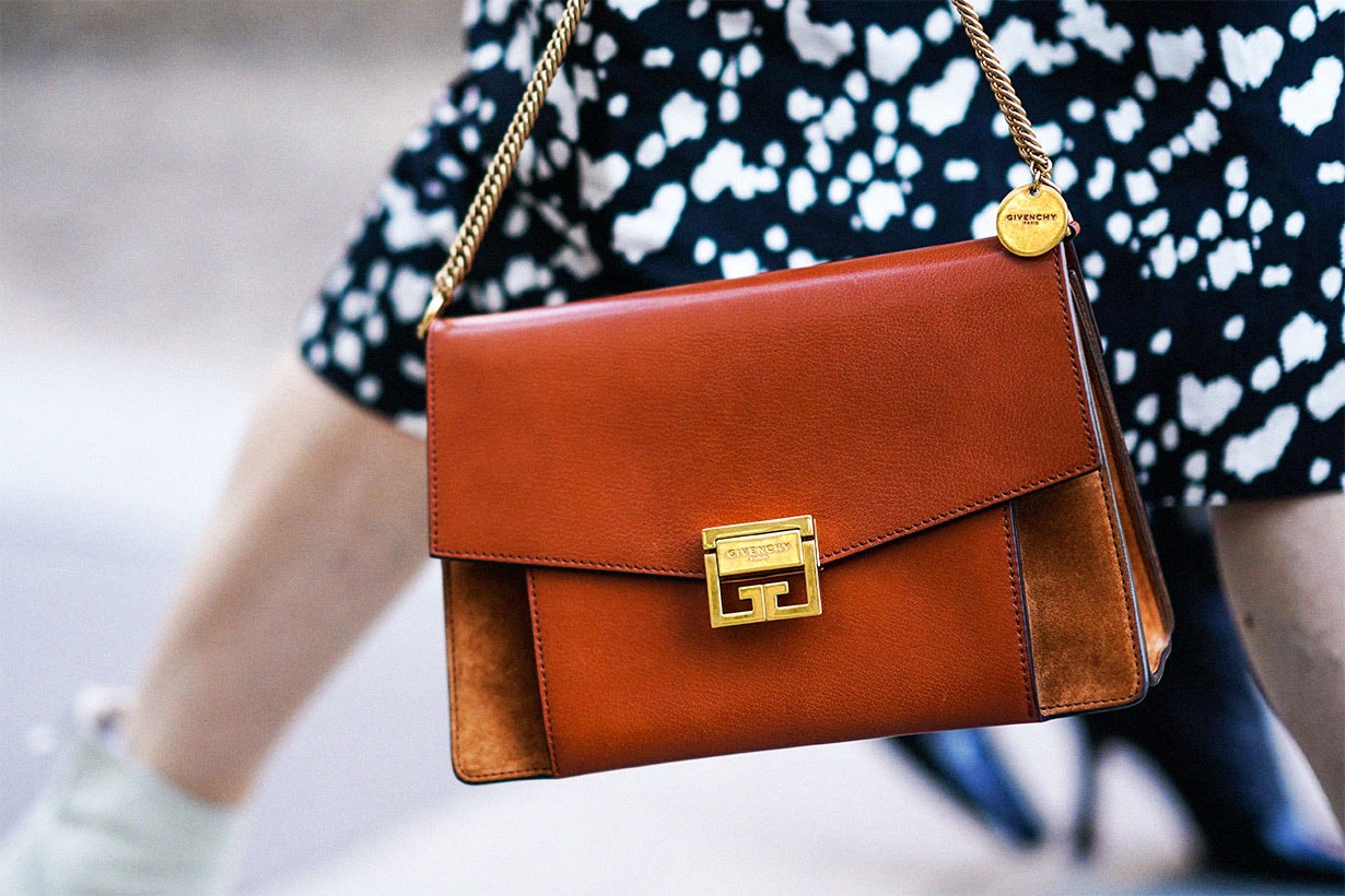 A guest wears a brown leather Givenchy bag, during London Fashion Week September 2019 on September 14, 2019 in London, England.