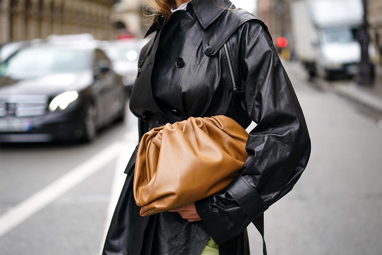 A guest wears a black leather coat and a brown leather Bottega Veneta bag, outside Giambattista Valli, during Paris Fashion Week - Womenswear Fall/Winter 2020/2021, on March 02, 2020 in Paris, France.