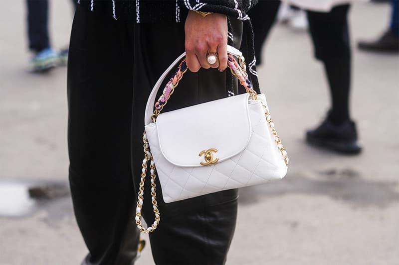 A guest wears a white Chanel bag, outside Chanel, during Paris Fashion Week - Womenswear Fall/Winter 2020/2021 on March 03, 2020 in Paris, France.