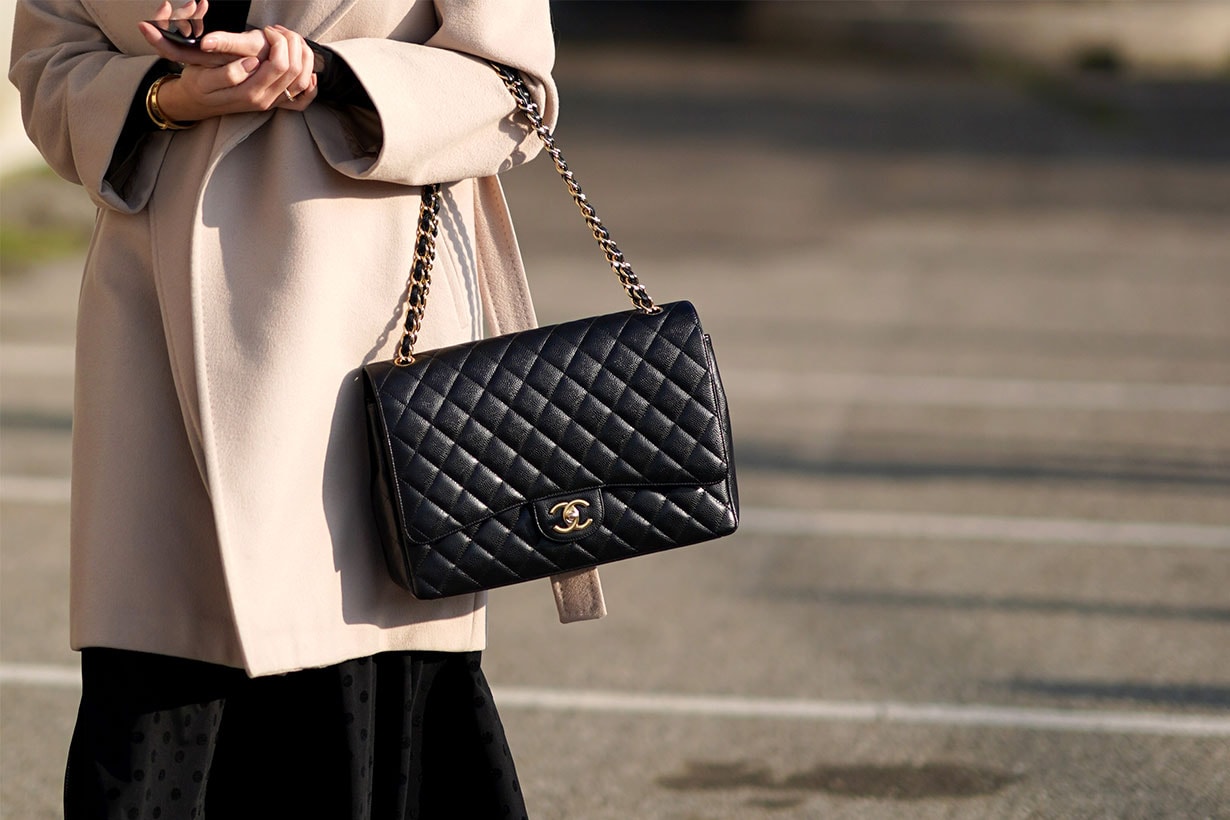A guest wears a black quilted Chanel bag, outside Alberta Ferretti, during Milan Fashion Week Fall/Winter 2020-2021, on February 19, 2020 in Milan, Italy.