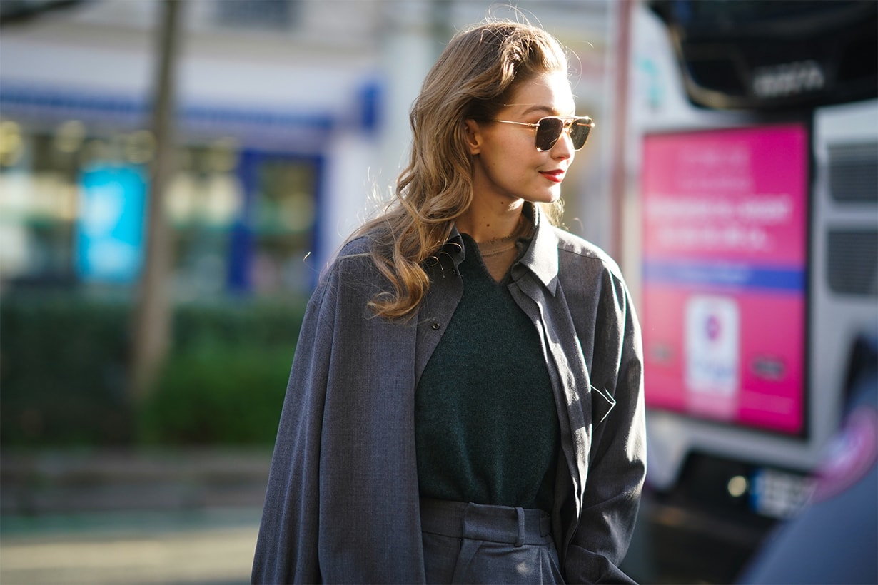 Gigi Hadid wears sunglasses, a gray jacket, a green wool pullover, outside Lanvin, during Paris Fashion Week - Womenswear Fall/Winter 2020/2021, on February 26, 2020 in Paris, France.