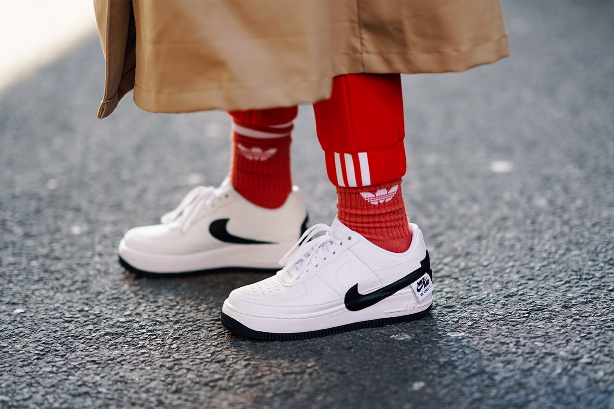 Nike white sneakers shoes, Adidas red socks, during London Fashion Week February 2019 on February 15, 2019 in London, England.