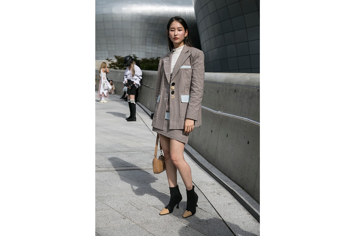 A guest is seen wearing plaid blazer and skirt during the Seoul Fashion Week 2020 S/S at Dongdaemun Design Plaza on October 17, 2019 in Seoul, South Korea. 