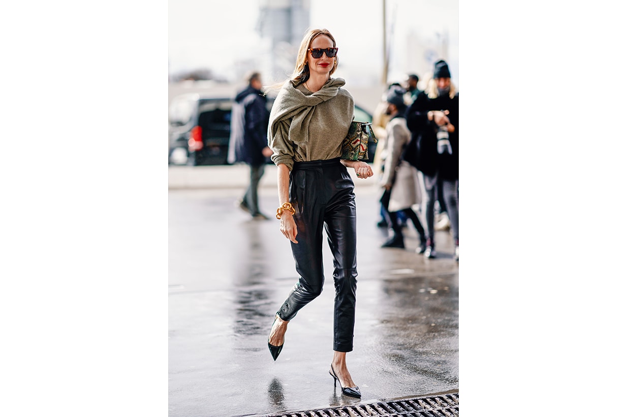 Lauren Santo Domingo wears sunglasses, earrings, a grey sweater, black leather pants, a shiny colorful bag, shiny pumps, outside Giambattista Valli, during Paris Fashion Week Womenswear Fall/Winter 2019/2020, on March 04, 2019 in Paris, France. 