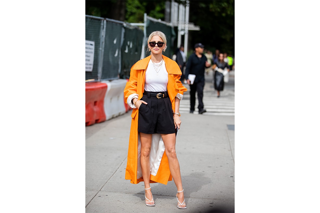 Caroline Caro Daur is seen wearing shorts, orange coat outside Tory Burch during New York Fashion Week September 2019 on September 08, 2019 in New York City.